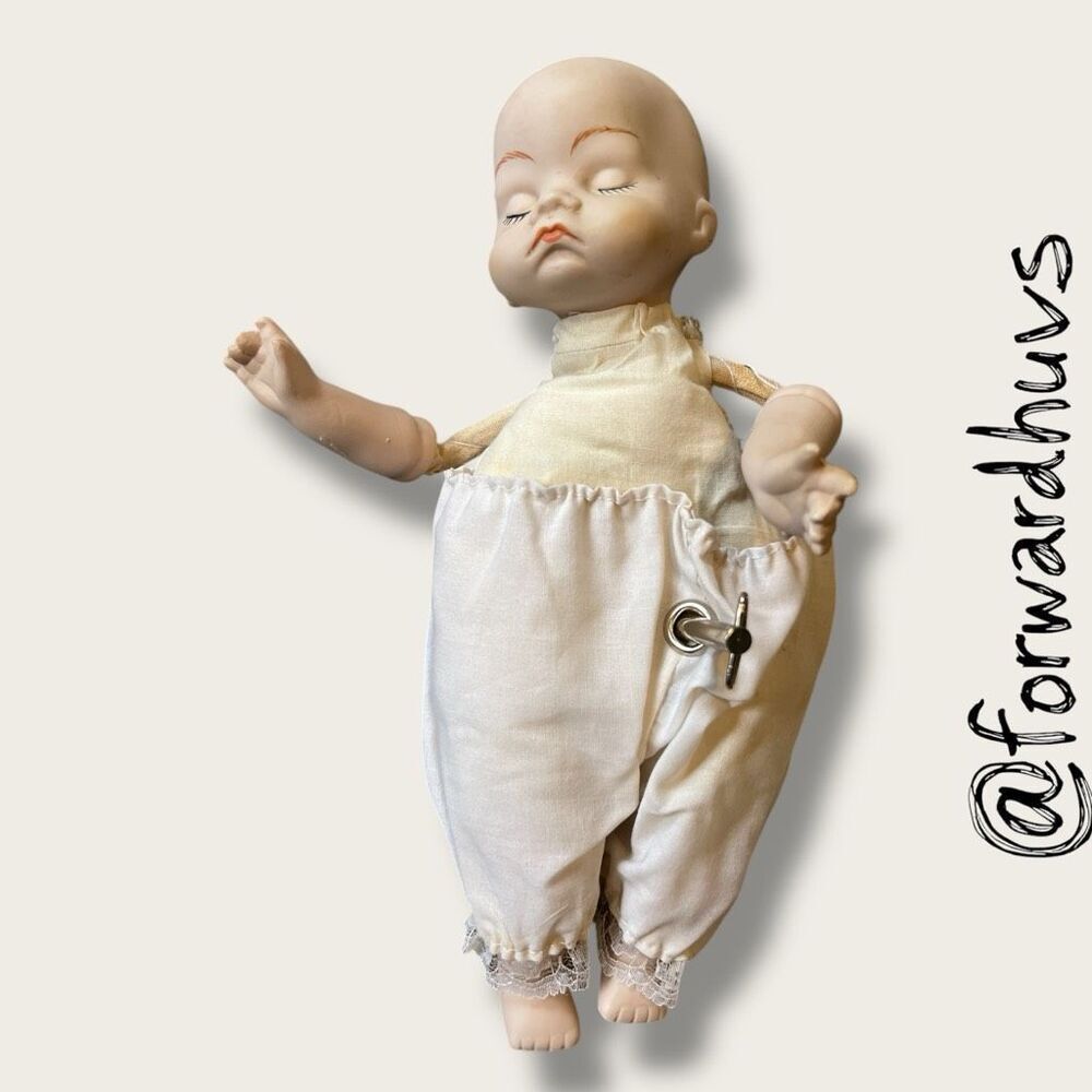 Wind-Up Musical Porcelain Doll – Moving Head & Arms - UNKNOWN AGE